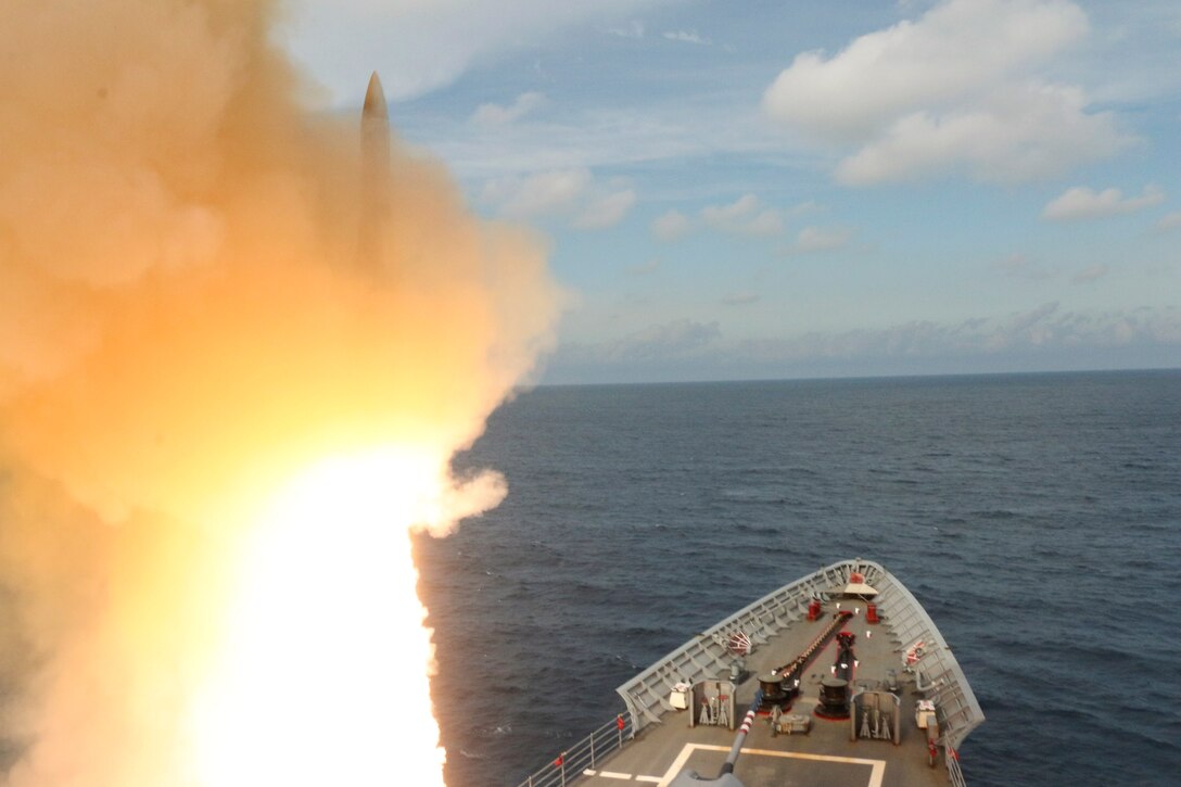 A missile launches from a ship in the ocean during training.