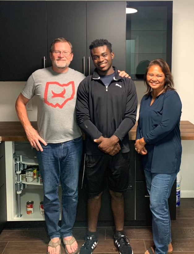 Retired Senior Master Sgt. Pete Peel and his wife Ning help refugee children and teens in the Dayton, Ohio area. They are pictured with Tole Kikubi, a refugee from Congo.