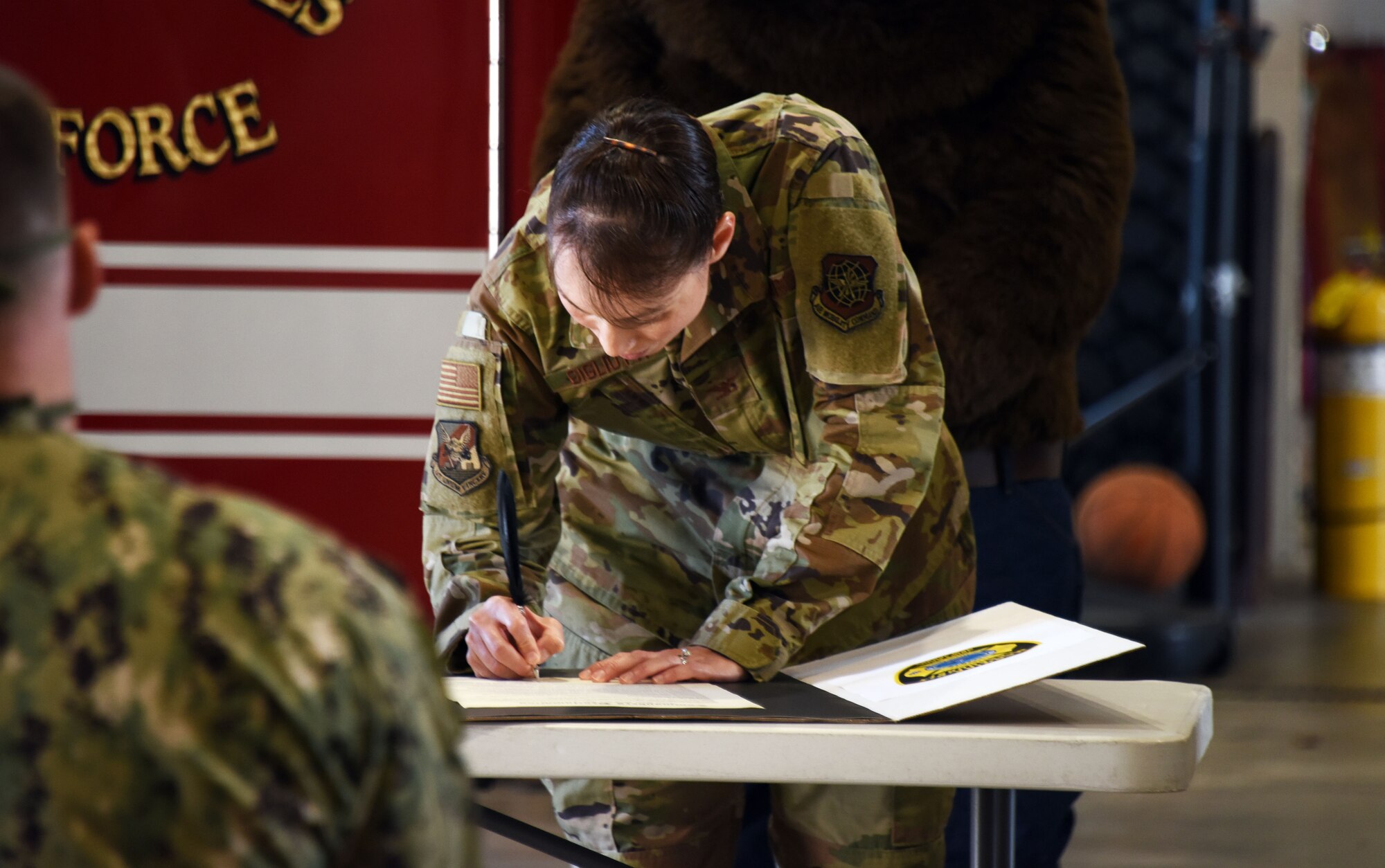 Photo of an individual signing a proclamation.