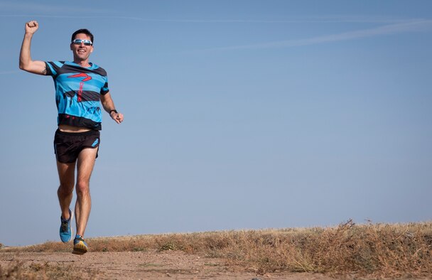 Jason Brosseau, 26th Space Aggressors Squadron, raises his fist as he approaches the finish line during the 15th annual half marathon Oct. 2, 2020, at Schriever Air Force Base, Colorado. Brosseau came in first place with a time of 1 hour, 25 minutes and 37 seconds. (U.S. Space Force photo by Airman 1st Class Jonathan Whitely)
