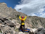 A Colorado Army National Guard UH-60 Black Hawk helicopter from the Army Aviation Support Facility, Buckley Air Force Base, Aurora, Colorado, approaches a member of the Alpine Rescue Team and an injured climber in Rocky Mountain National Park Aug. 30, 2019. The Colorado Hoist Rescue Team provides hoist extraction capability to those in need throughout Colorado by incorporating civilian alpine rescue personnel and military helicopter capabilities. (Used with permission Rocky Mountain National Park / Alpine Rescue Team)
