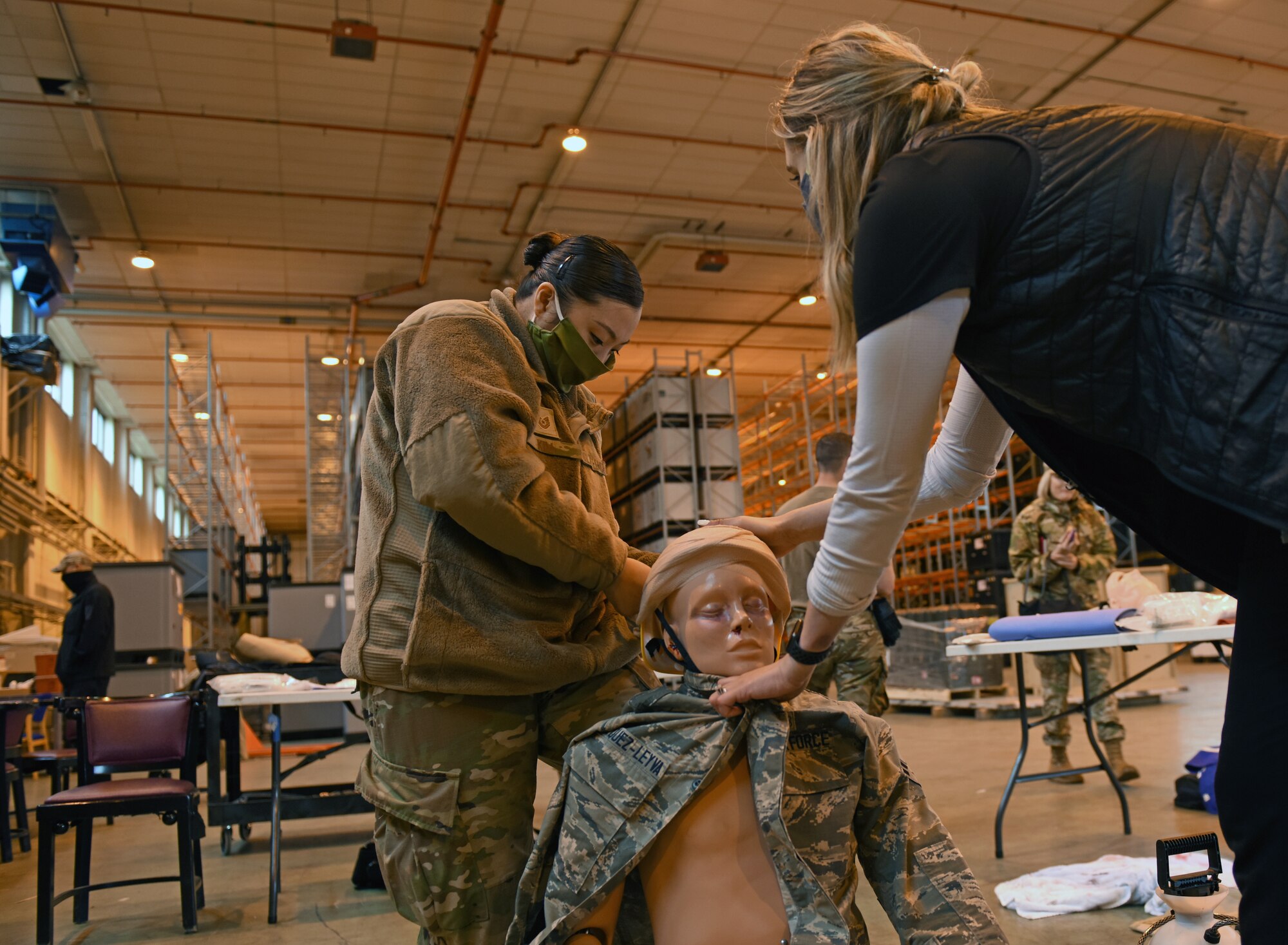 Tech. Sgt. Angela Kim, emergency medical service program manager at the 48th Medical Group, prepares a medical simulation manikin for Mission Assurance Exercise 20-20 at Royal Air Force Feltwell, England, Sept. 29, 2020. During the exercise, medical personnel received unique training and challenged their proficiency, practicing medical skills and procedures while treating simulated injuries in a forward operating location. (U.S. Air Force photo by Airman 1st Class Rhonda Smith)