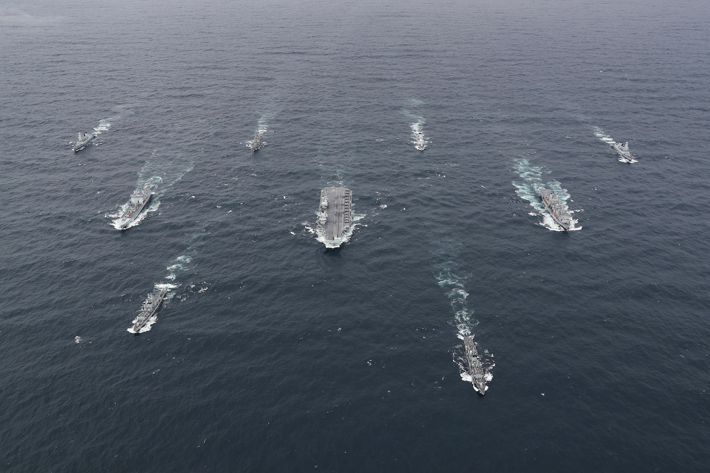 The full United Kingdom (UK) Carrier Strike Group (CSG) sails in formation for a photo exercise (PHOTOEX).