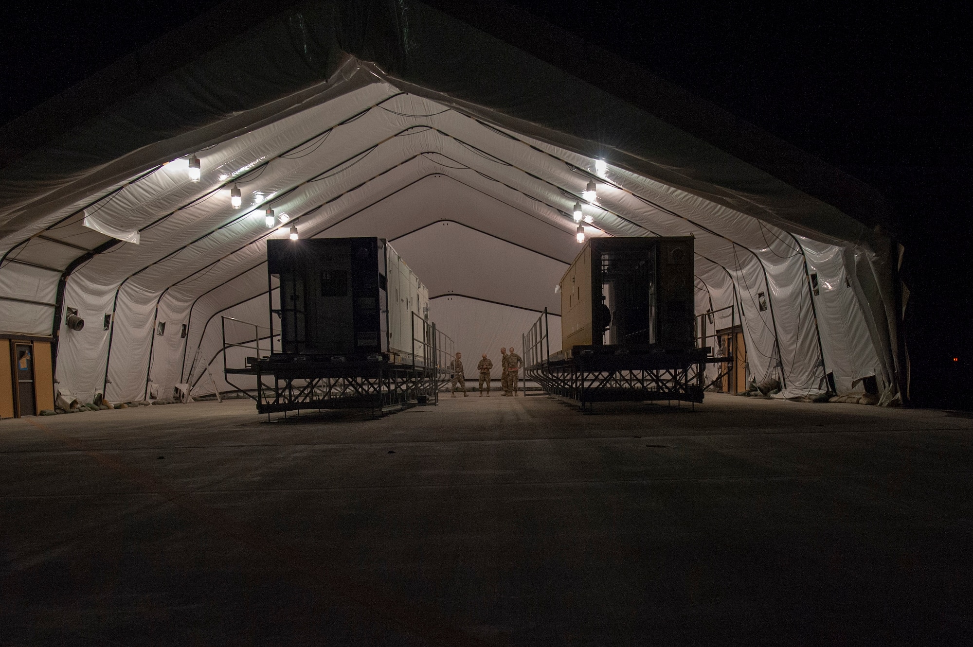 A specialized medical container designed to transport individuals with infectious diseases sits in a clamshell hangar on the flight line of Al Udeid Air Base, Qatar, on Sept. 18, 2020. The Negatively Pressurized Conex-Lite is a smaller variation of the Negatively Pressurized Conex and is configured to safely transport up to nine patients, including ambulatory and litter, around the globe.