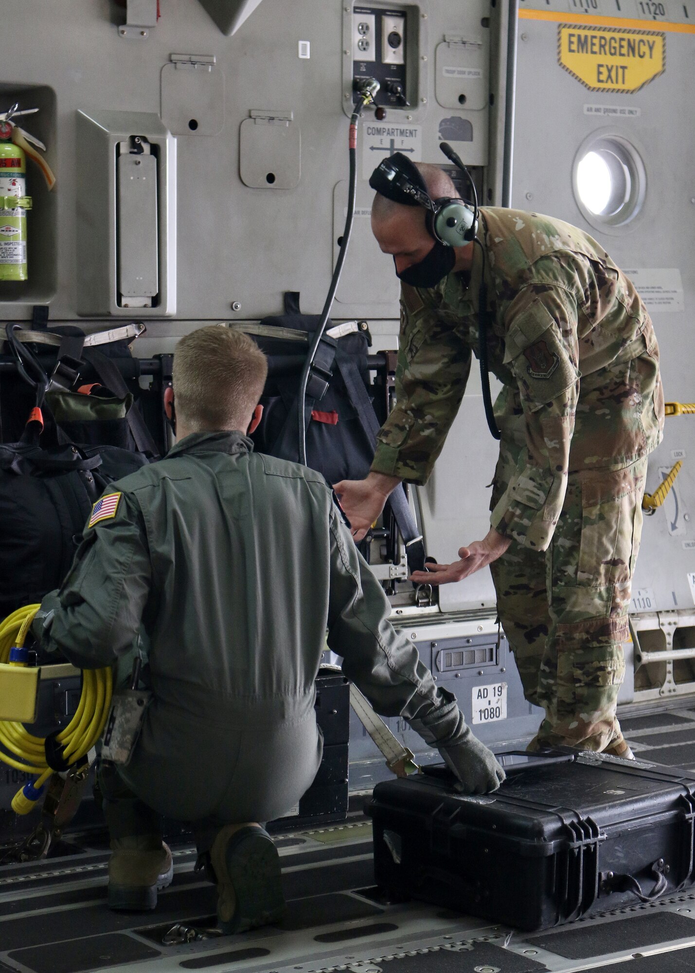 Tech. Sgt. Nickolaus Burns, 445th Aeromedical Evacuation Squadron flight instructor, shows a U.S. Air Force School of Aerospace Medicine student how to properly configure the medical equipment on a 445th Airlift Wing C-17 Globemaster III in preparation for an aeromedical evacuation training flight Sept. 14, 2020. Burns was one of four Reserve Citizen Airmen who augmented active duty cadre at the schoolhouse in September.