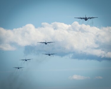 Five C-130H Hercules aircraft assigned to the 103rd Airlift Wing fly over Westover Air Reserve Base in Chicopee, Massachusetts, Oct. 4, 2020. The “Max Fly” mission challenges the unit to fly the maximum amount of aircraft in its fleet in a single mission in a comprehensive display of the unit’s readiness and tactical airlift capabilities.