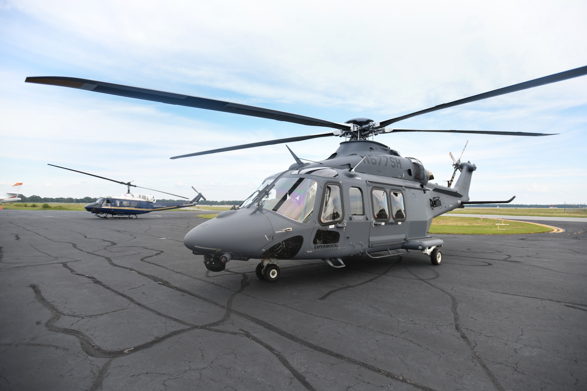 A UH-1N Huey (left) and an MH-139A Grey Wolf (right) sit side-by-side at an airfield in Richmond, Va., July 30, 2020.