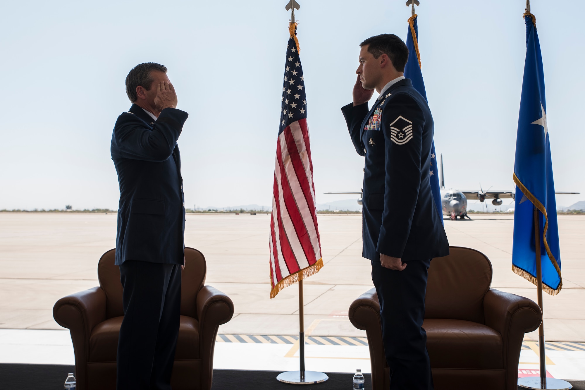 A photo of Airmen saluting during a medal presentation ceremony