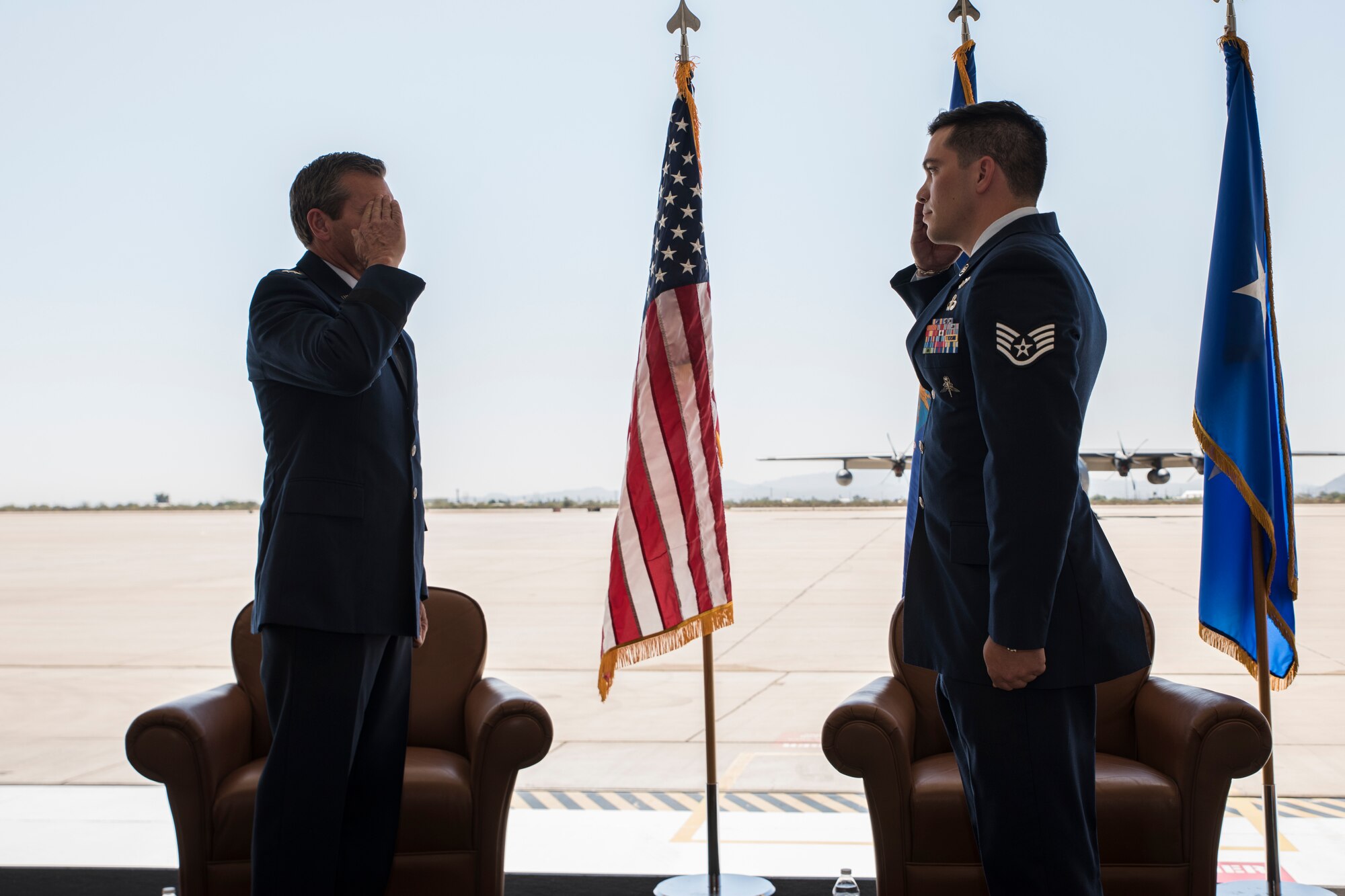 A photo of Airmen saluting during a medal presentation ceremony