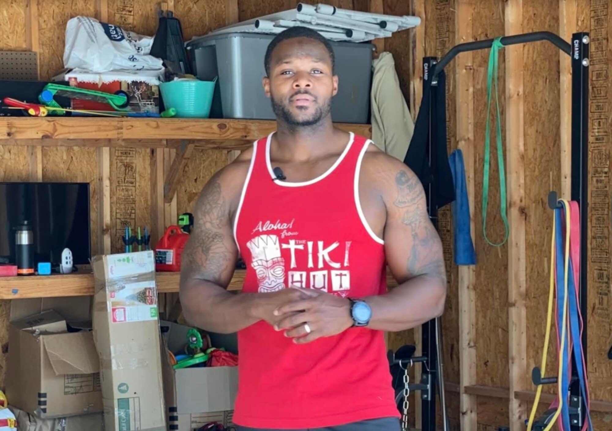 Man in red tank top.