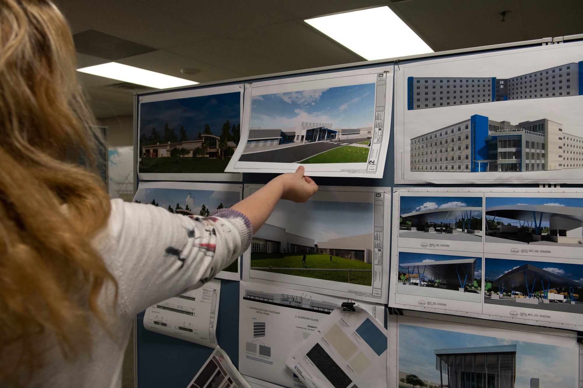 Woman shows pictures of future buildings