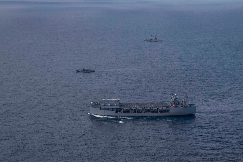 Ships transit a body of water.