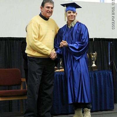 Mountaineer ChalleNGe Academy cadet Davey Hayes poses with West Virginia Senator Joe Manchin during MCA graduation ceremonies. Hayes has taken on a new role as Group Leader at the newly opened Mountaineer ChalleNGe Academy - South located in Montgomery, West Virginia, and hopes to use his personal experience with the program to help new cadets prosper in the program. (Courtesy Photo)