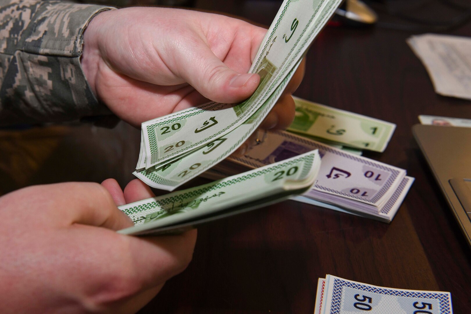 A person counts money.