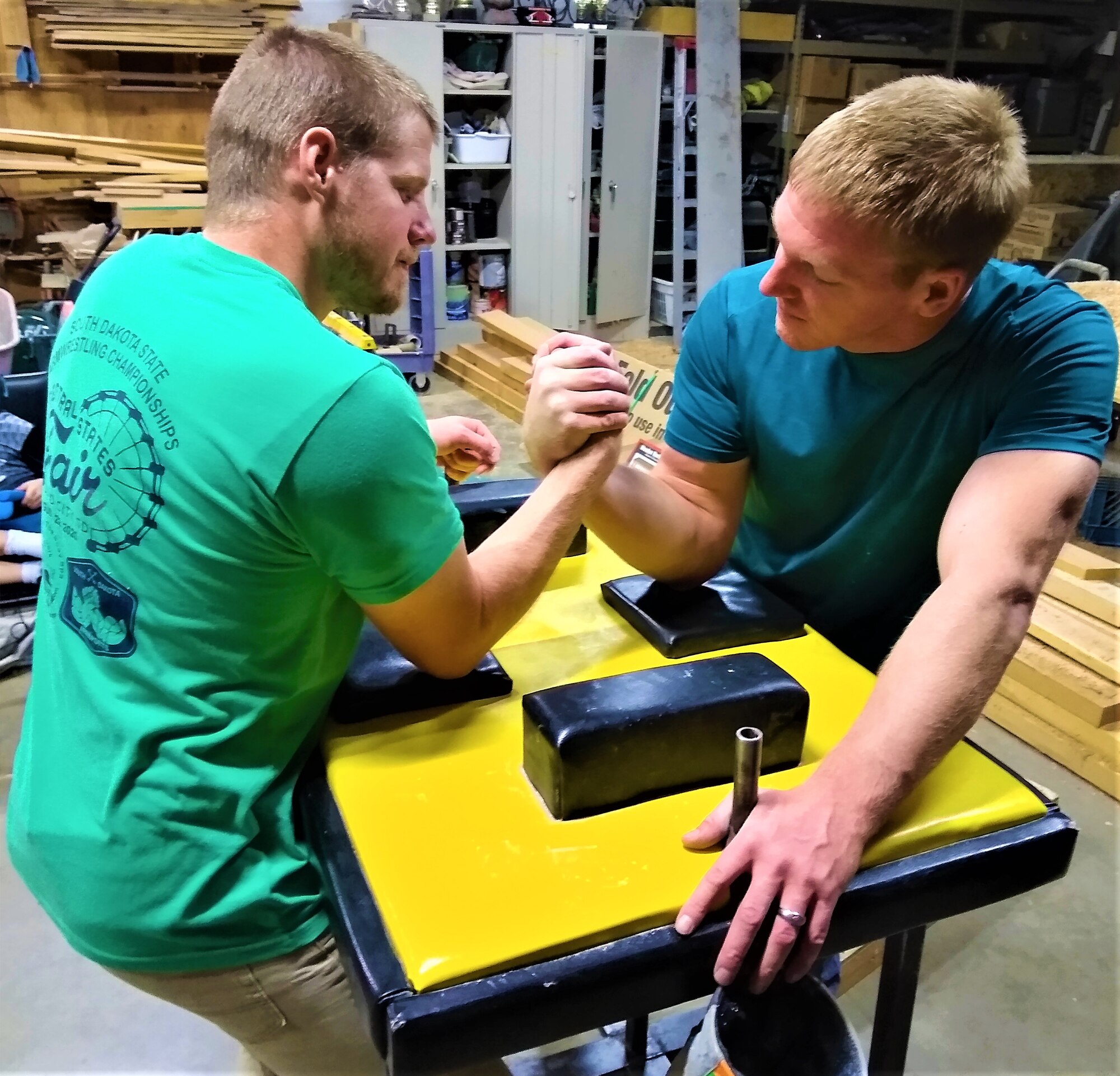 Team Hill employees Lincoln Jarman (left) and 1st Lt. Chad Wanner arm wrestling during a training session Oct. 1 in Logan, Utah. Wanner is a seasoned veteran, with 16 years of experience in competitive arm wrestling, while Jarman has just one year under his belt.