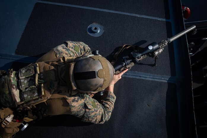 A U.S. Marine sights in with an M110 semi-automatic sniper system on the USS Germantown during a simulated visit, board, search, and seizure mission aboard USS New Orleans (LPD 18).