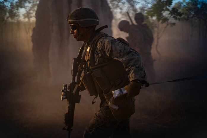 U.S. Marines and Australian Army members work together to breach barbwire barriers while conducting bang rushes during Exercise Koolendong at Mount Bundey Training Area, NT, Australia, Sept. 9.