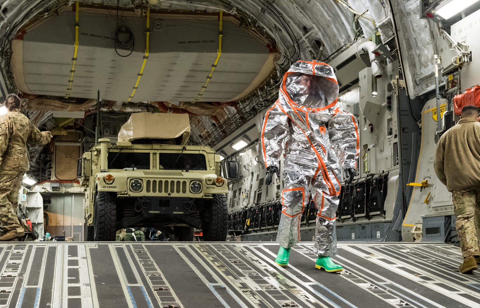 U.S. Army Maj. Mark Quint, 20th Chemical, Biological, Radiological, Nuclear and Explosives Command nuclear disablement team deputy chief, walks down the ramp of a C-17 Globemaster III, wearing personal protective equipment Sept. 19, 2020, at Dover Air Force Base, Delaware. The 20th CBRNE Command recently conducted a deployment readiness exercise, which consisted of several inspections, aerial troop movements and convoys. The 20th CBRNE Command ensures the effective countering of CBRNE hazards at home and abroad. Dover AFB serves as the primary port of embark for the 20th CBRNE Command during both exercises and operations and regularly supports similar joint missions. (U.S. Air Force photo by Roland Balik)