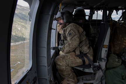 Chief Warrant Officer 2 Ryan Johnson, with with Company C, 1st Battalion, 244th Aviation Regiment, Oklahoma Army National Guard, looks out the left crew chief position in a UH-60 "Black hawk" during a training exercise in Colorado Springs, Colorado, Sept. 14-18. The Oklahoma unit is flying in support of training exercise Operation Lead Bucket. The exercise is intended to provide challenging hands-on training focused on improved flying in high altitudes. (Oklahoma Army National Guard photo by Pfc. Emily White)