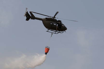 Members of a UH-72 "Lakota" crew with the 244th Aviation Regiment, Oklahoma Army National Guard practice dropping water from a Bambi bucket during Operation Lead Bucket, a training event in Colorado Springs, Colorado, Sept. 14-18. Operation Lead Bucket is intended to provide challenging hands-on training focused on improved flying in high altitudes. (Oklahoma Army National Guard photo by Pfc. Emily White)