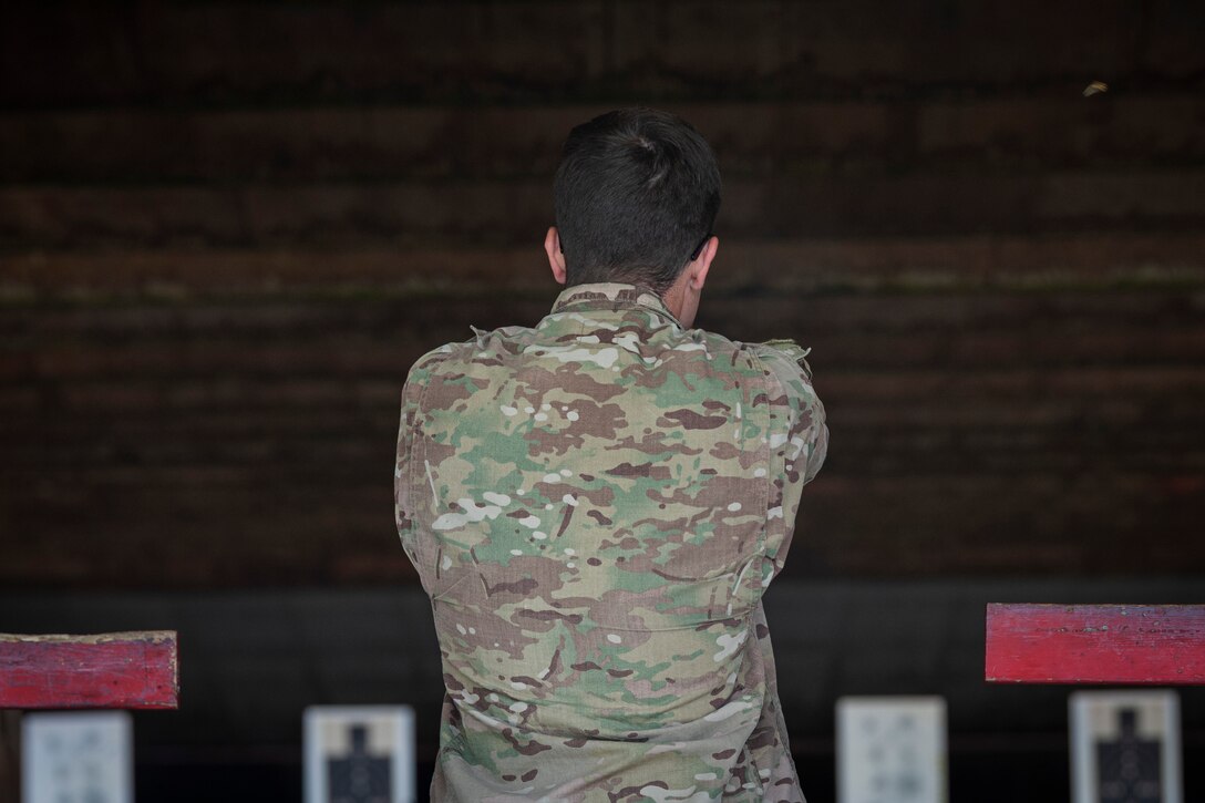 Photo of an Airman shooting a handgun