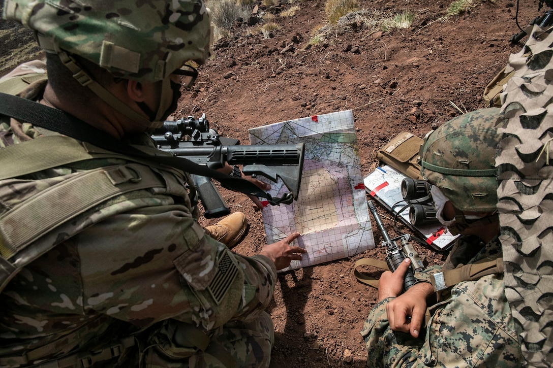 U.S. Marines with 1st Battalion, 12th Marine Regiment and U.S. Army Soldiers with 3rd Battalion, 7th Field Artillery Regiment, occupy Observation Point Ahi, Pohakuloa Training Area, Hawaii, Sept. 19, 2020. Marines and soldiers conducted forward artillery observation as part of Exercise Spartan Fury, a joint effort led by 1/12 that stresses service cohesion, expeditionary readiness, and a free exchange of knowledge and skills between the two artillery units. (U.S. Marine Corps photo by Sgt. Luke Kuennen)