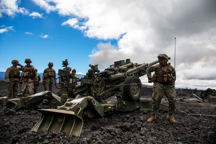 U.S. Marine Corps Pfc. Cameron White,  a cannoneer with Charlie Battery, 1st Battalion, 12th Marine Regiment, pulls the lanyard of an M777A2 Howitzer duringan artillery raid aboard Pohakuloa Training Area, Hawaii, Sept. 25, 2020. The training event, supported by Marine Medium Tiltrotor Squadron 363, Marine Heavy Helicopter Squadron 463, and Combat Logistics Battalion 3 was a part of Spartan Fury, a training exercise that aims to strengthen 1/12's expeditionary readiness and tactical proficiency. (U.S. Marine Corps photo by Sgt. Luke Kuennen)