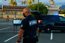 A member of the base fire department observes a mishap drill, Marine Corps Base Hawaii, Sept. 29, 2020. The mishap drill was conducted in order to maintain readiness and strengthen cohesion between emergency services aboard MCBH. (U.S. Marine Corps photo by Lance Cpl. Shane Linder)