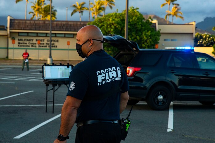 A member of the base fire department observes a mishap drill, Marine Corps Base Hawaii, Sept. 29, 2020. The mishap drill was conducted in order to maintain readiness and strengthen cohesion between emergency services aboard MCBH. (U.S. Marine Corps photo by Lance Cpl. Shane Linder)