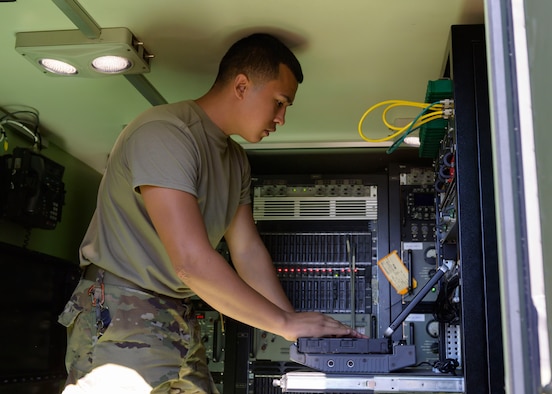 Airman David Jasso,726th Air Control Squadron radio frequency transmission technician, configures radio frequency for air-to-ground communications inside a Radio Unit - 214 (RU-214), Sept. 30, 2020, at Grasmere Range, Idaho. The 726 ACS use the RU-214 to transmit communications during live exercise and operations. (U.S. Air Force photo by Staff Sgt. Tyrell Hall)