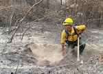 Senior Airman Payton Chiou, 225th Support Squadron, Western Air Defense Sector, helps the Washington State Department of Natural Resources fight wildfires near Inchelium, Washington, Sept. 16, 2020. The 15-person Air National Guard crew spent more than 10 days fighting fires in eastern Washington.