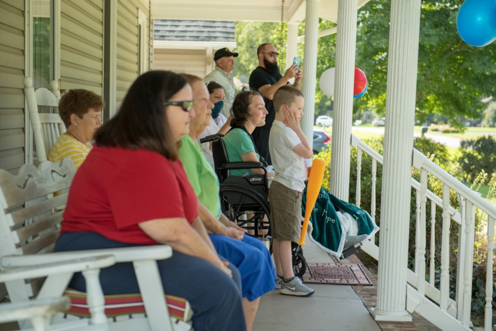 People on a porch watch