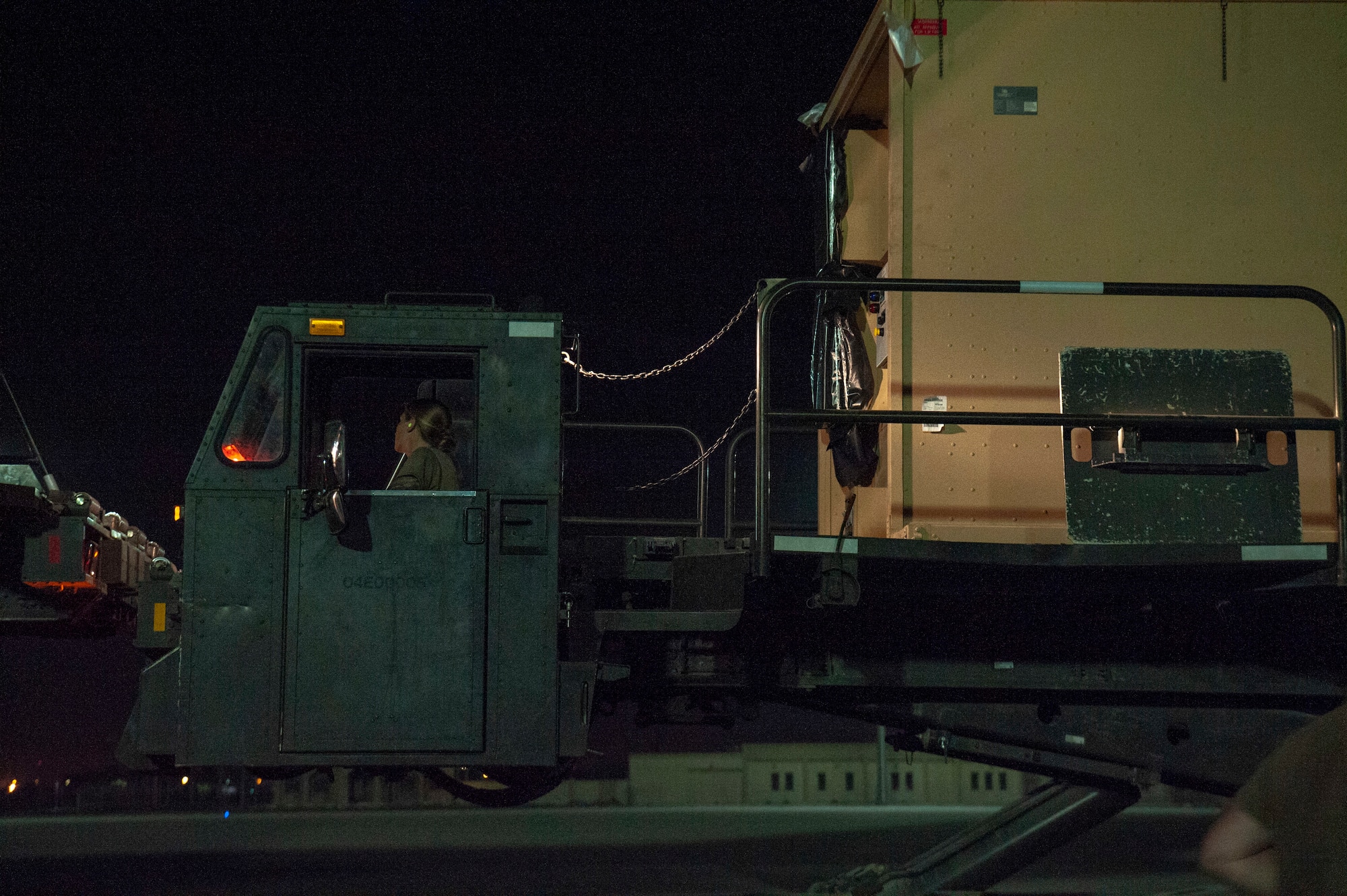 Airmen prepare to off load a specialized medical container designed to transport individuals with infectious diseases at Al Udeid Air Base, Qatar, Sept. 25, 2020. The Negatively Pressurized Conex-Lite, or NPC-L, is configured for the C-130 Hercules aircraft to safely transport up to nine patients, including ambulatory and litter, around the globe.