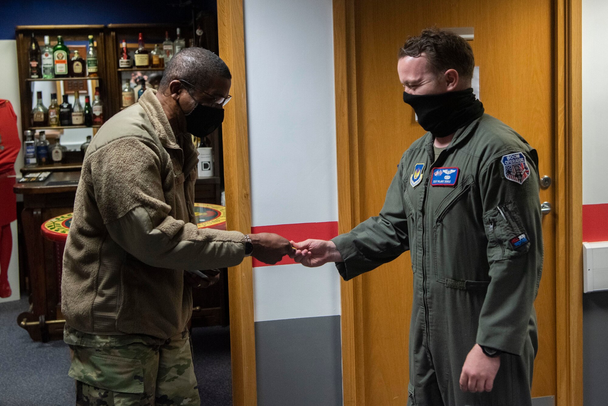 Maj. Gen. Randall Reed, Third Air Force commander, left, coins Staff Sgt. Blake Soule, 351st Air Refueling Squadron boom operator, at Royal Air Force Mildenhall, England, Sept. 24, 2020. Reed and Chief Master Sgt. Randall Kwiatkowski, Third Air Force command chief, showed their appreciation for Airmen across the installation during their visit to U.S. Air Forces in Europe and Air Forces Africa’s only air refueling wing. (U.S. Air Force photo by Airman 1st Class Joseph Barron)