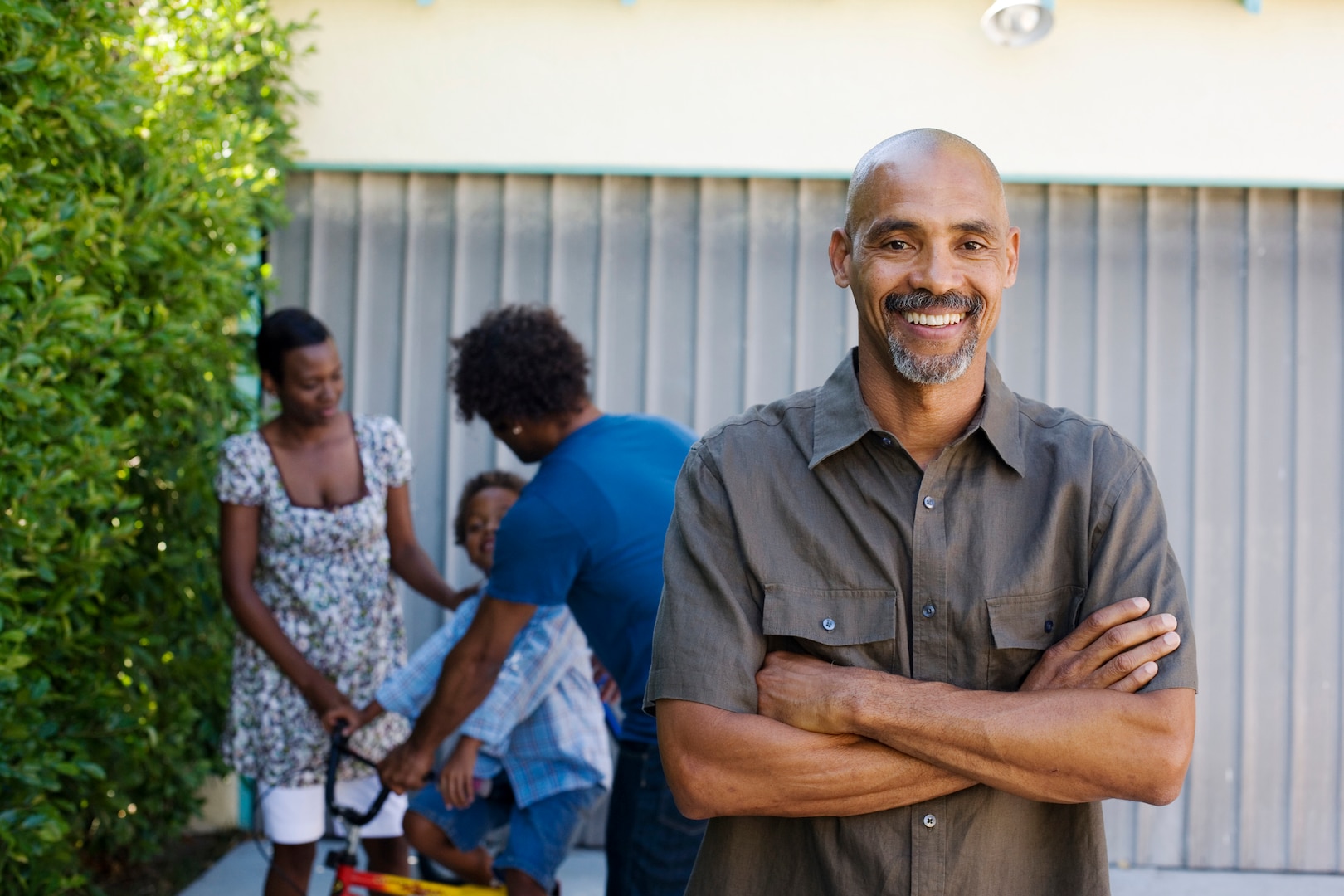 man smiling with arms crossed