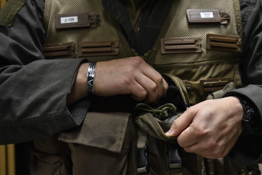Maj. Houston “Meat” Pye, 8th Fighter Wing chief of safety and 80th Fighter Squadron pilot, adjusts his vest before flight at Kunsan Air Base, Republic of Korea, Aug. 31, 2020.