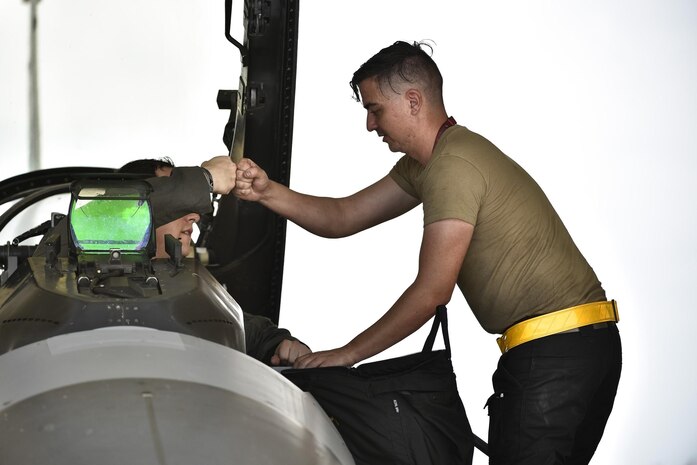 Maj. Houston “Meat” Pye, 8th Fighter Wing chief of safety and 80th Fighter Squadron pilot, greets Senior Airman Christopher Ryan-Shulls, 80th Aircraft Maintenance Unit crew chief, before his flight at Kunsan Air Base, Republic of Korea, Aug. 31, 2020.