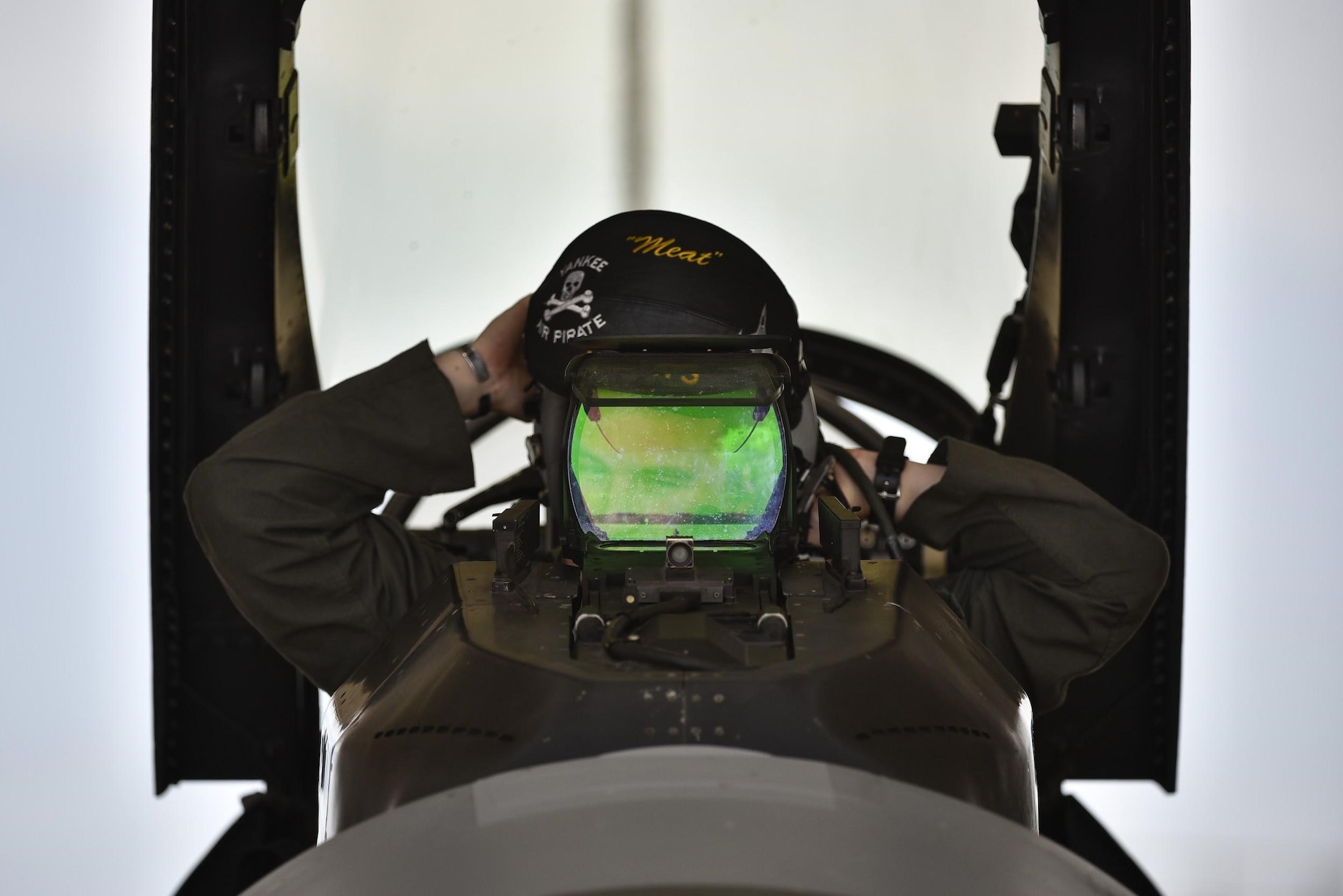 Maj. Houston “Meat” Pye, 8th Fighter Wing chief of safety and 80th Fighter Squadron pilot, dons his pilot helmet before flight at Kunsan Air Base, Republic of Korea, Aug. 31, 2020.