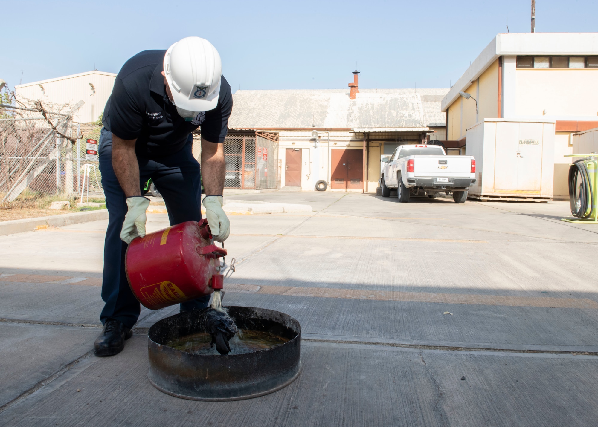 Firefighter douses rag with gas.