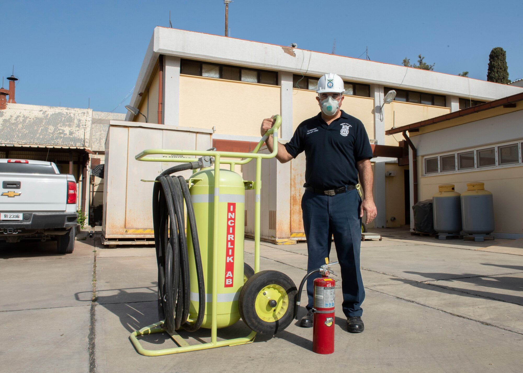 Firefighter poses next to equipment.