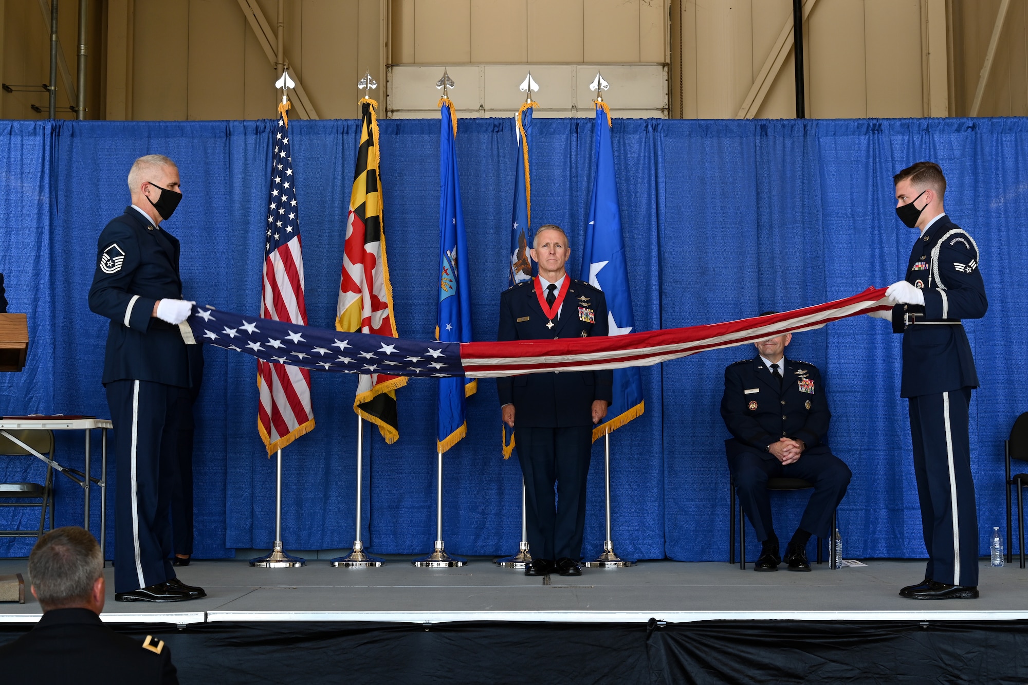 Members from the Maryland National Guard Honor Guard Team fold a flag that was presented to Maj. Gen. Paul C. Maas, Jr., the National Guard assistant to the commander of U.S. Cyber Command, director of the National Security Agency, and Central Security Service chief during his retirement ceremony, Oct. 3, 2020 at the 175th Wing, Maryland Air National Guard, Middle River, Md. Maas retired after 42 years of service in the United States Air Force. (U.S. Air National Guard photo by Tech. Sgt. Enjoli Saunders)