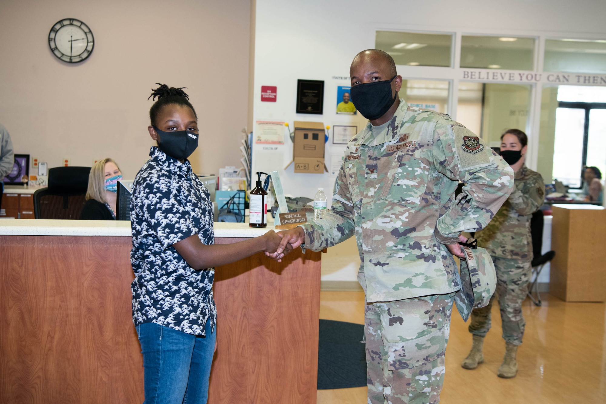 Alexia Jordan, daughter of 436th Contracting Squadron superintendent Senior Master Sgt. Andrea Jordan, receives a challenge coin from Col. Phelemon Williams, 436th Mission Support Group commander, at the youth center, Sept. 28, 2020, at Dover Air Force Base, Delaware. Jordan has been awarded $27,500 in scholarship funds from Boys & Girls Club of America. (U.S. Air Force photo by Mauricio Campino)