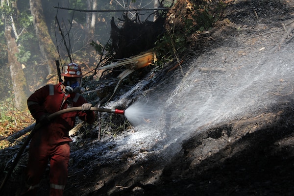 A contractor spays special foam on a coal fire at an abandoned Navy coal mine in Cumberland, Washington, August, 2020.
At the request of the Office of Surface Mining and Reclamation  the USACE Omaha District's rapid response team was asked to provide assistance. (Courtesy photo by Mr. Jeremy Ayala)