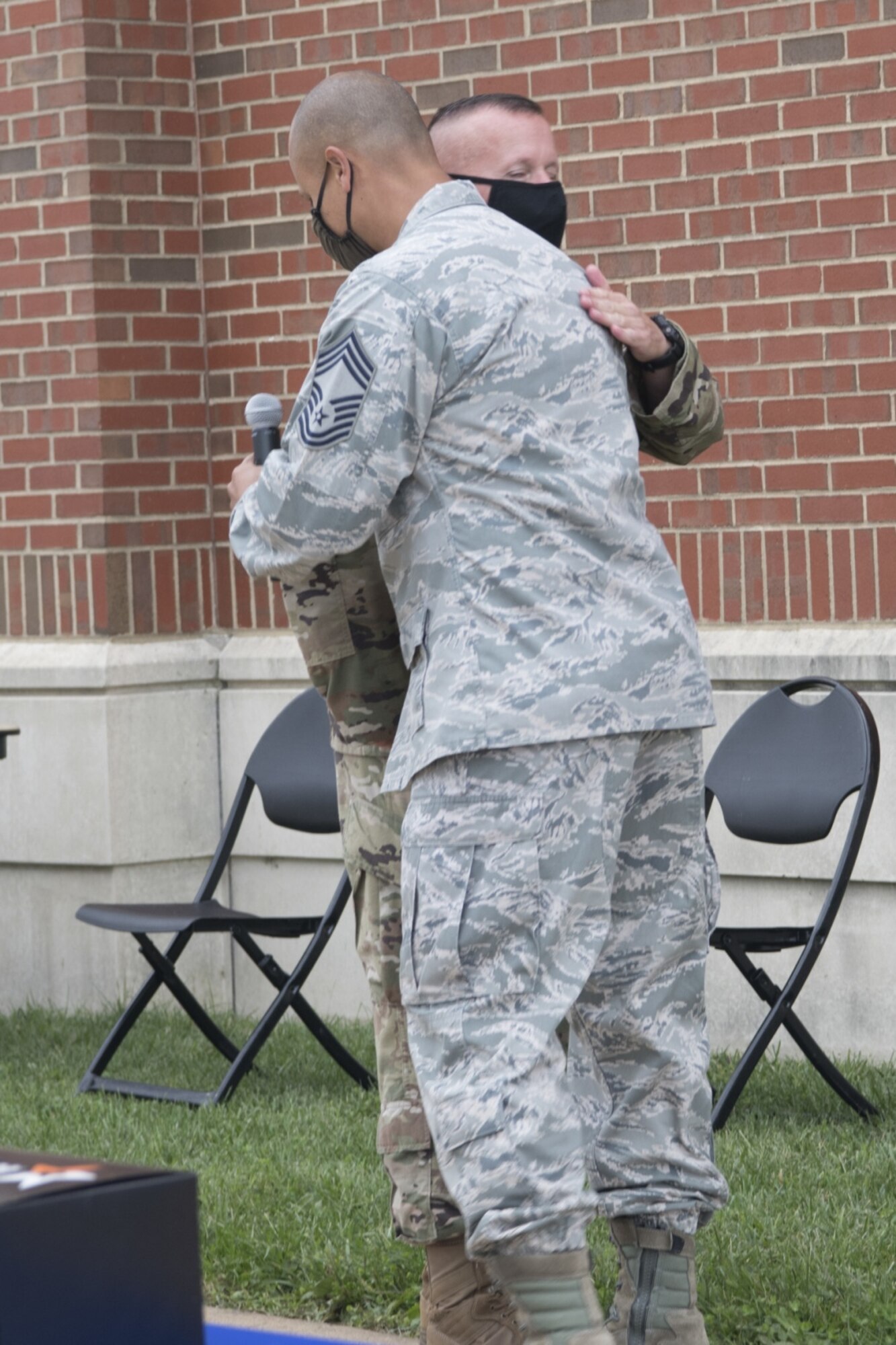 Two Airman hug