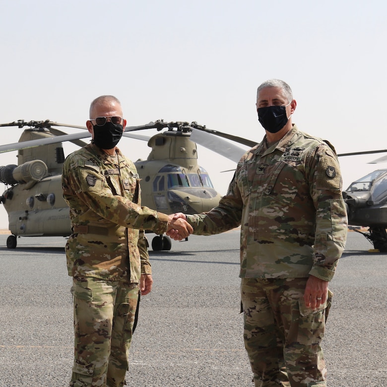 U.S. Army Col. Howard Lloyd, left, commander of the 28th Expeditionary Combat Aviation Brigade poses for a photo with Col. Greg Fix, commander of the 34th ECAB after a transfer of authority ceremony.