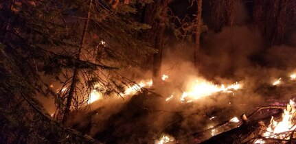 Wildland fires burn during a mid-August night near Susanville, Calif. A series of wildland fires has destroyed more than 30,000 acres of land around Susanville. Three intelligence analysts with the Michigan National Guard's 110th Operations Group deployed to California to assist fire teams with aerial footage from the unmanned MQ-9 Reaper.