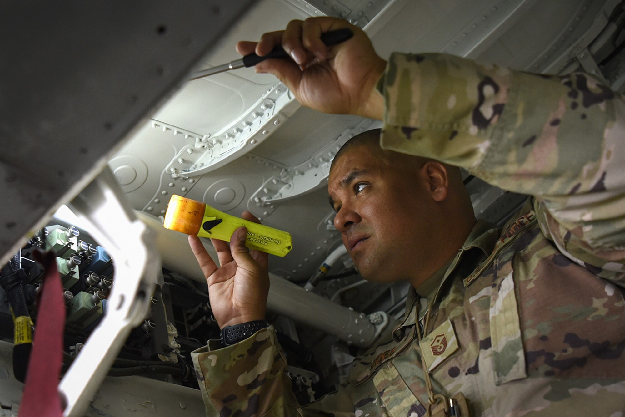 U.S. Air Force Master Sgt. Marvin Vides, 159th Fighter Wing Staff first sergeant and flight control specialist, inspects an F-15C’s main landing gear door mechanisms to check for loose fasteners or worn components at Naval Air Station - Joint Reserve Base New Orleans, La., Sept. 24, 2020. While performing his first sergeant duties, Vides focuses on readiness, health, morale, welfare and quality of life issues of the wing’s airmen to ensure they are successful. (U.S. Air National Guard photo by Staff Sgt. Ryan J. Sonnier)
