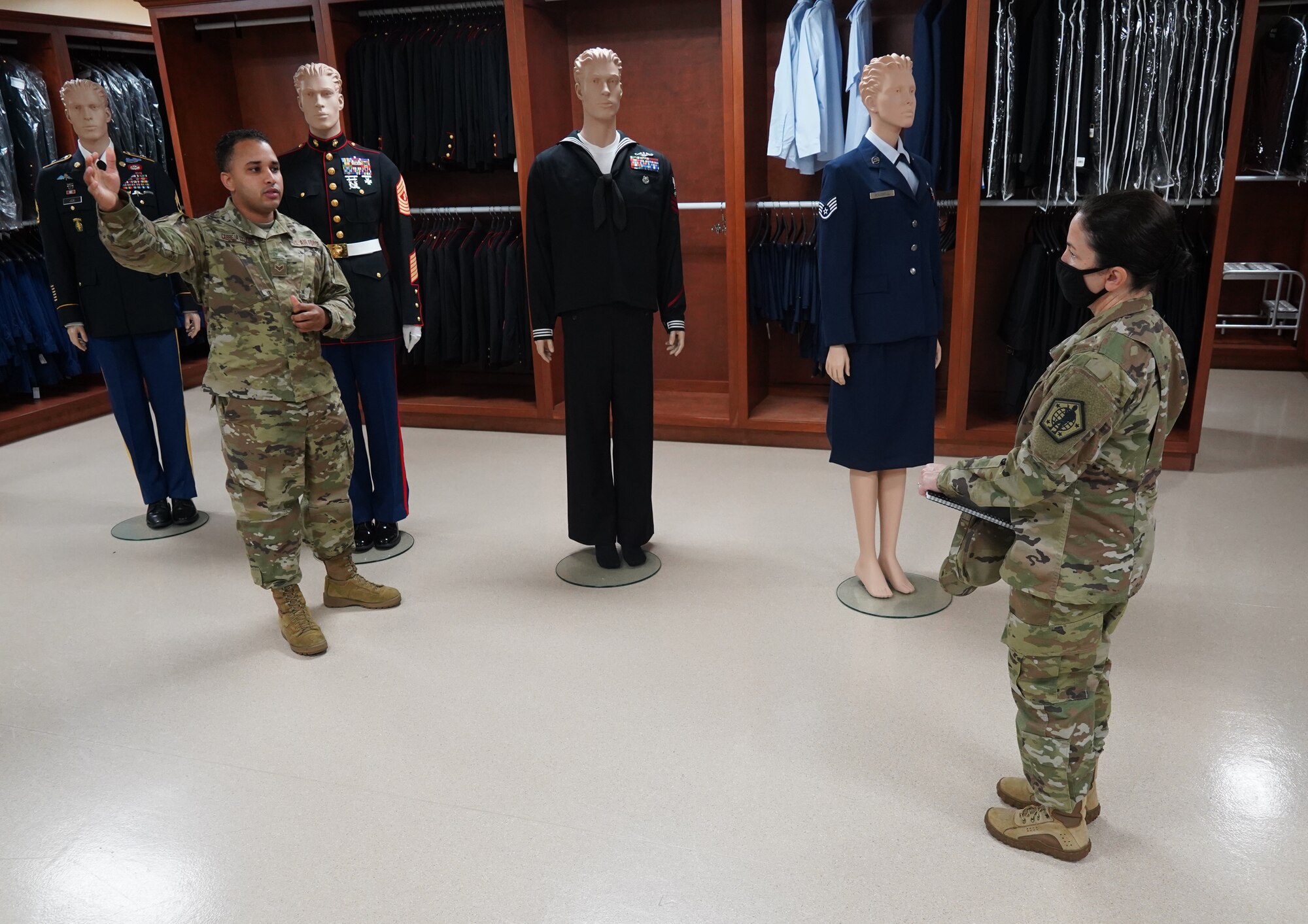 Senior Airman Wili Cabreja-Lozada, Air Force Mortuary Affairs Operations dress and restoration section lead, talks through the process of uniform preparation with Army Brig. Gen. Hope Rampy, Adjutant General of the Army, Oct. 6, 2020. In Rampy’s position as the TAG, she is responsible for Army casualty operations. The visit assisted in familiarization of the AFMAO, the Armed Forces Medical Examiner System and Joint Personal Effects Depot missions at Dover Air Force Base, Delaware. (U.S. Air Force photo by Staff Sgt. Benjamin N. Valmoja)