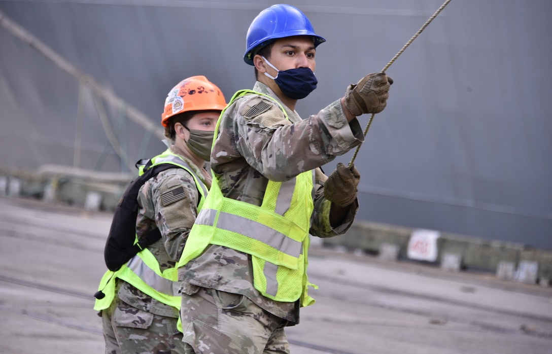 U.S. Army Soldiers download military vehicles from at Port Arthur, Texas.