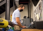 Adam Coffman, NSWC PCD computer engineer, performs cyber reconnaissance of the unmanned system. U.S. Navy photo by Anthony Powers